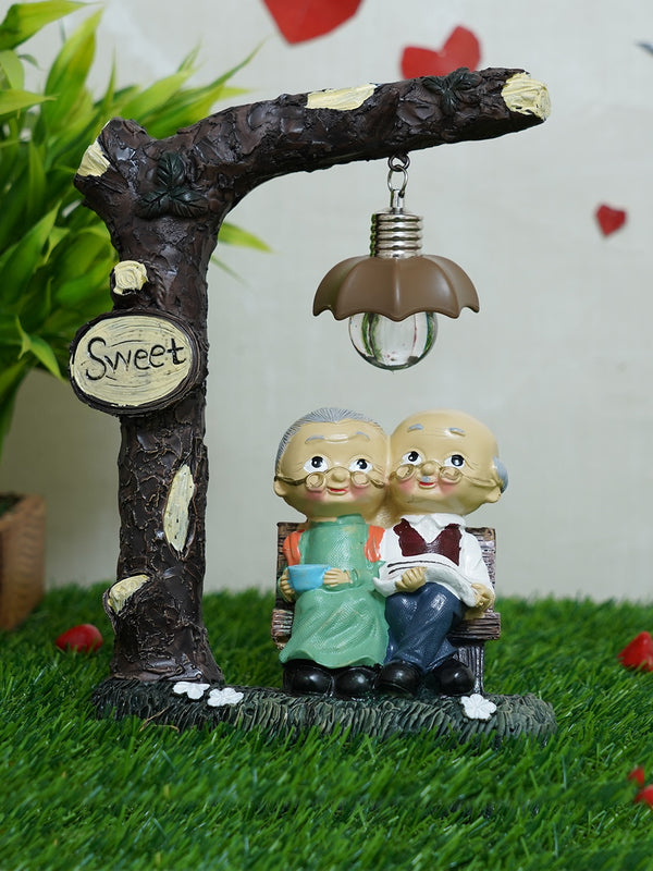 Brown and Beige Old Age Couple LED Light Showpiece